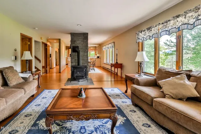 a living room with furniture rug and large windows