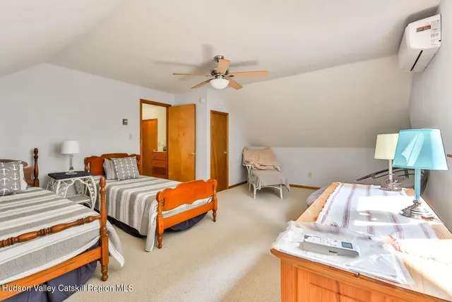a bedroom with two beds and painting on the wall