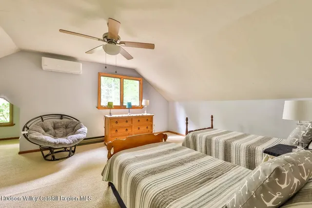 a bedroom with two beds and a window