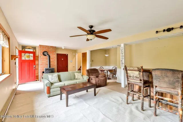 a living room with furniture and a ceiling fan