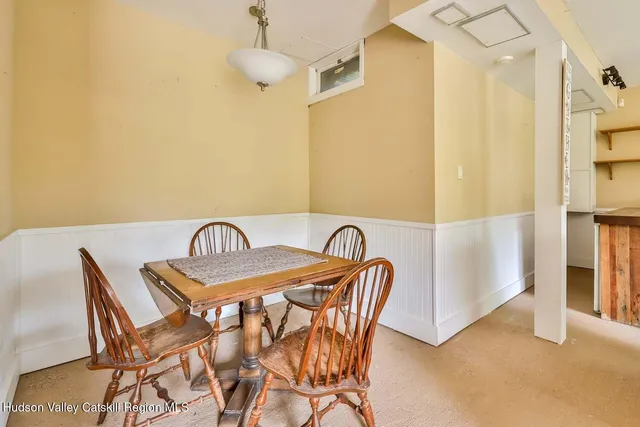 a view of a dining room with furniture and a chandelier