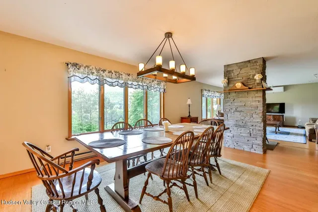 a view of a dining room with furniture wooden floor and chandelier