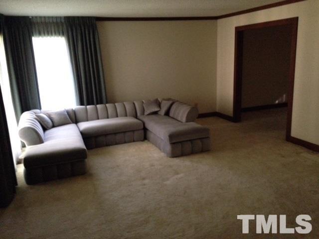 8908 Woodvine Court Raleigh, NC 27613 - Photo 3 of 8 a living room with furniture and a window
