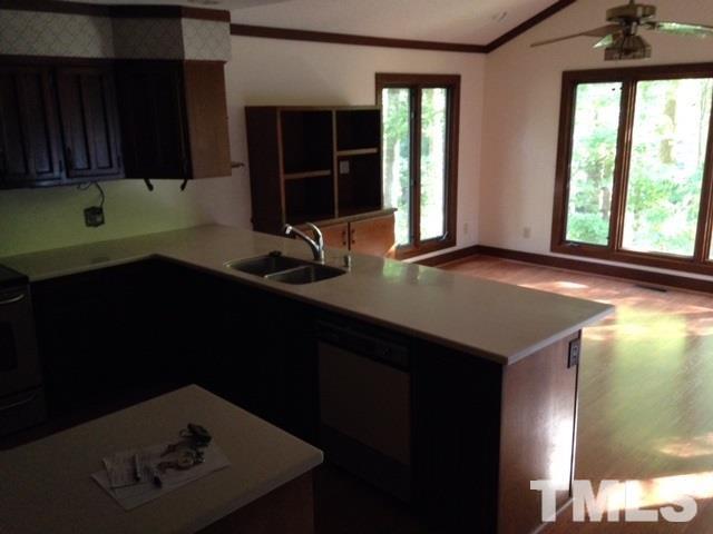 8908 Woodvine Court Raleigh, NC 27613 - Photo 5 of 8 a kitchen with a sink a window and cabinets