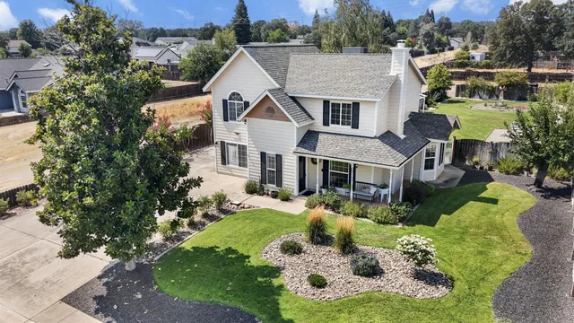 a aerial view of a house with yard swimming pool and outdoor seating