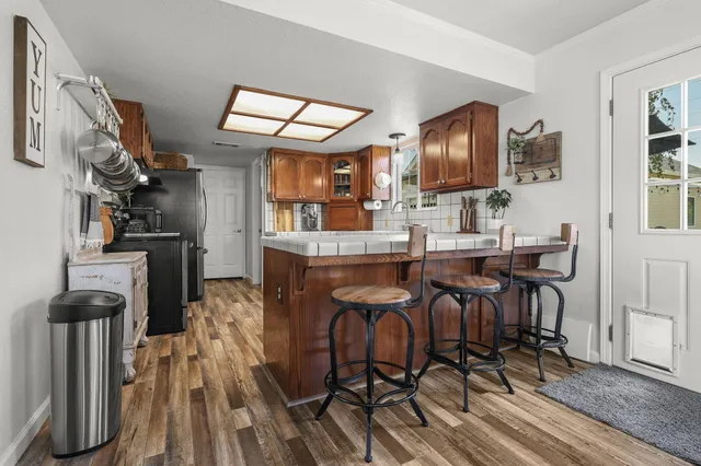 a kitchen with stainless steel appliances granite countertop a sink and cabinets