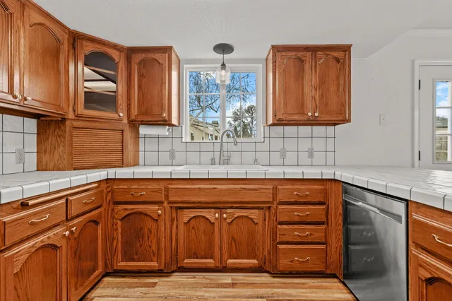a bathroom with a granite countertop toilet sink and mirror