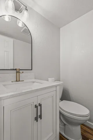 a view of an empty room with a window and a ceiling fan