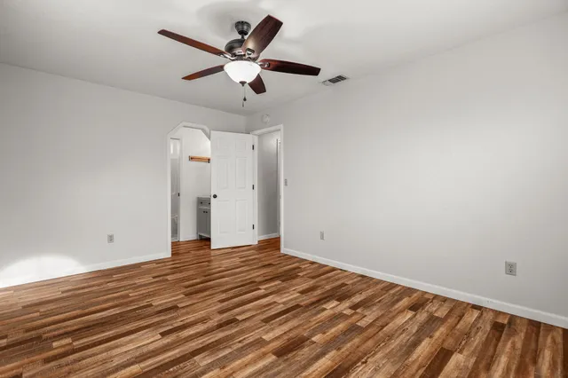 a view of a room with wooden floor