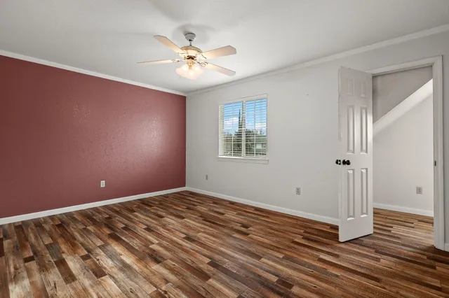 a view of a backyard with grass and a garden