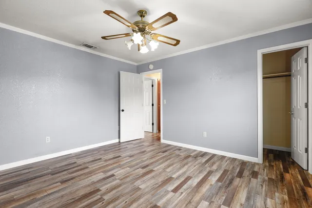 a front view of a house with a garden and plants