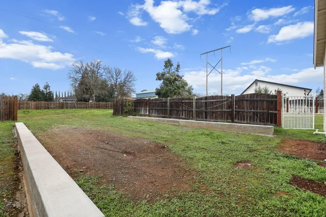 a view of a house with a yard and garage