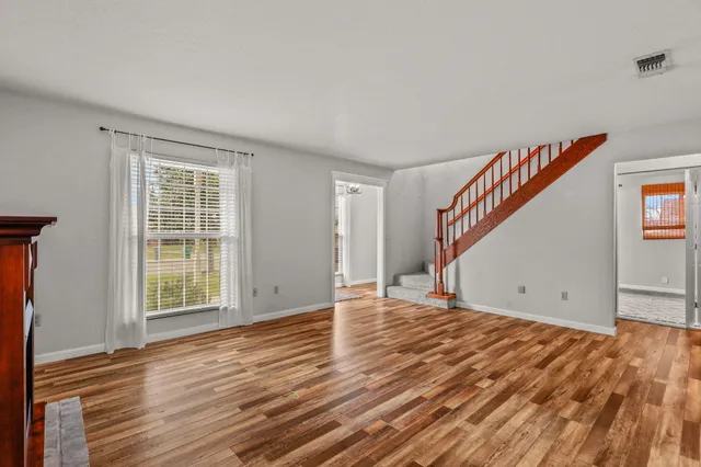 a view of a dining room with furniture window and wooden floor