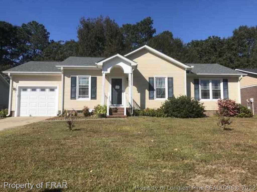 6516 Applewhite Road Fayetteville, NC 28304 - Photo 1 of 12 a front view of house with yard and trees in the background