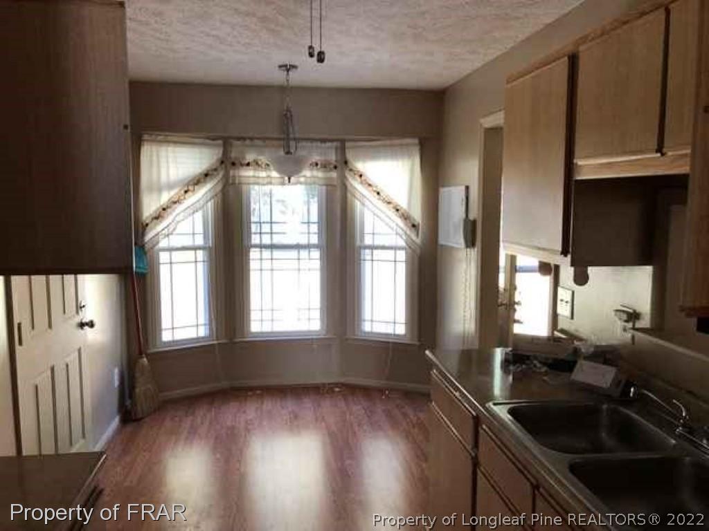 6516 Applewhite Road Fayetteville, NC 28304 - Photo 7 of 12 a kitchen with granite countertop a sink and a stove