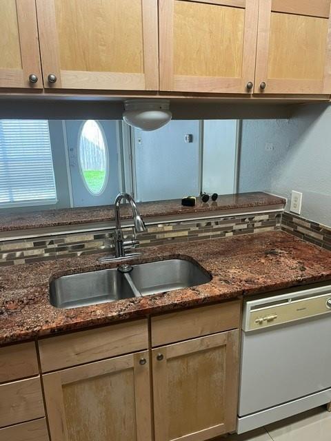 339 Fantail Loop, Unit B Austin, TX 78734 - Photo 5 of 13 a kitchen with granite countertop a sink and a stove