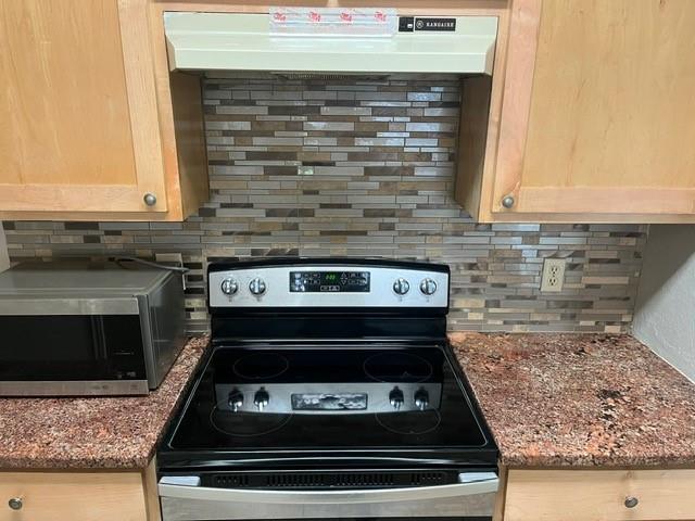 339 Fantail Loop, Unit B Austin, TX 78734 - Photo 6 of 13 a stove top oven sitting inside of a kitchen