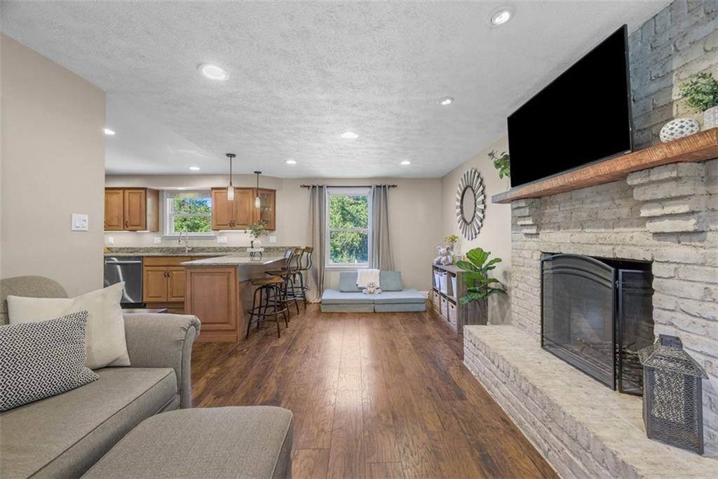 229 Lakeside Drive McKees Rocks, PA 15136 - Photo 14 of 35 a living room with furniture a fireplace and a flat screen tv