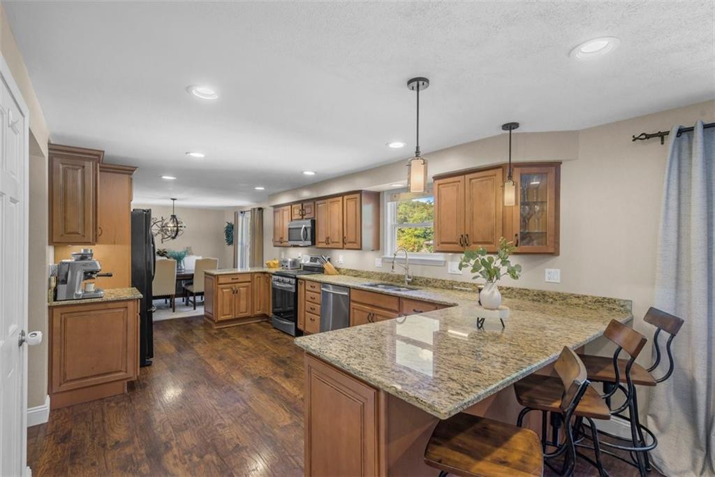 229 Lakeside Drive McKees Rocks, PA 15136 - Photo 8 of 35 a kitchen with stainless steel appliances granite countertop sink stove and refrigerator
