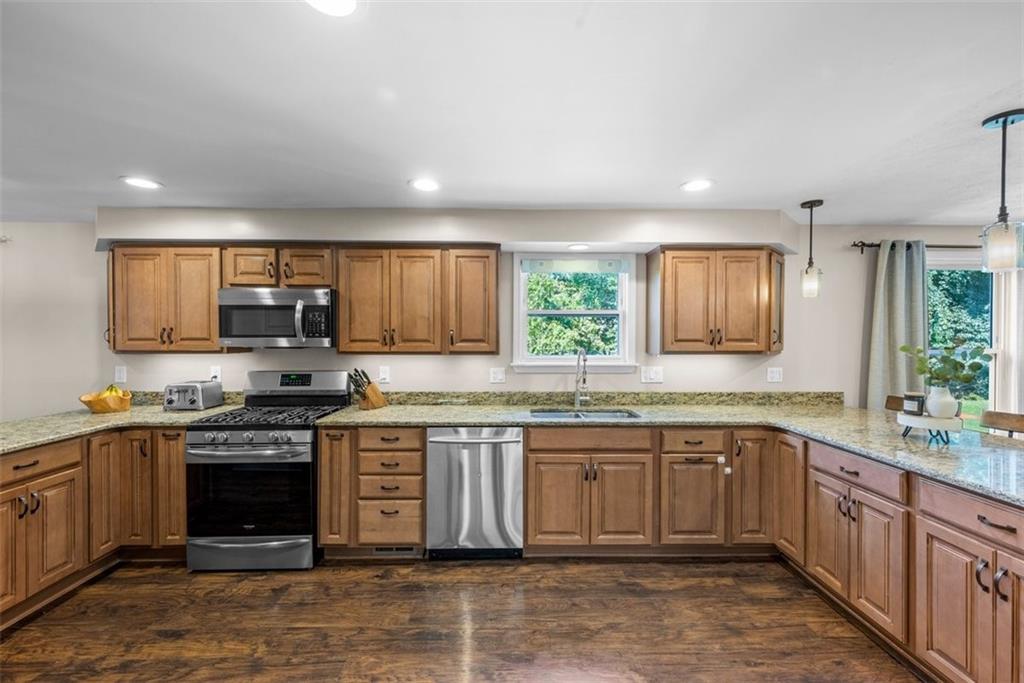 229 Lakeside Drive McKees Rocks, PA 15136 - Photo 10 of 35 a kitchen with stainless steel appliances granite countertop a stove sink and cabinets