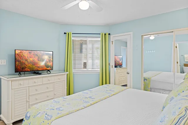 a bedroom with a bed and a flat screen tv