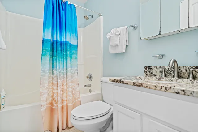 a kitchen with stainless steel appliances granite countertop a kitchen island hardwood floor sink stove and refrigerator