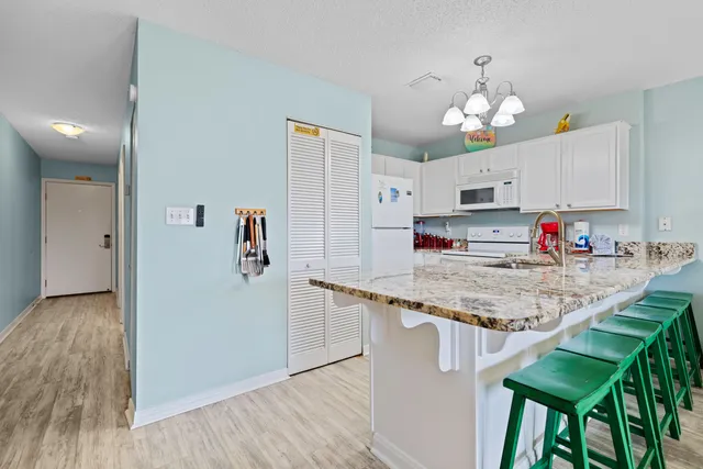 a kitchen with stainless steel appliances granite countertop a sink and a stove