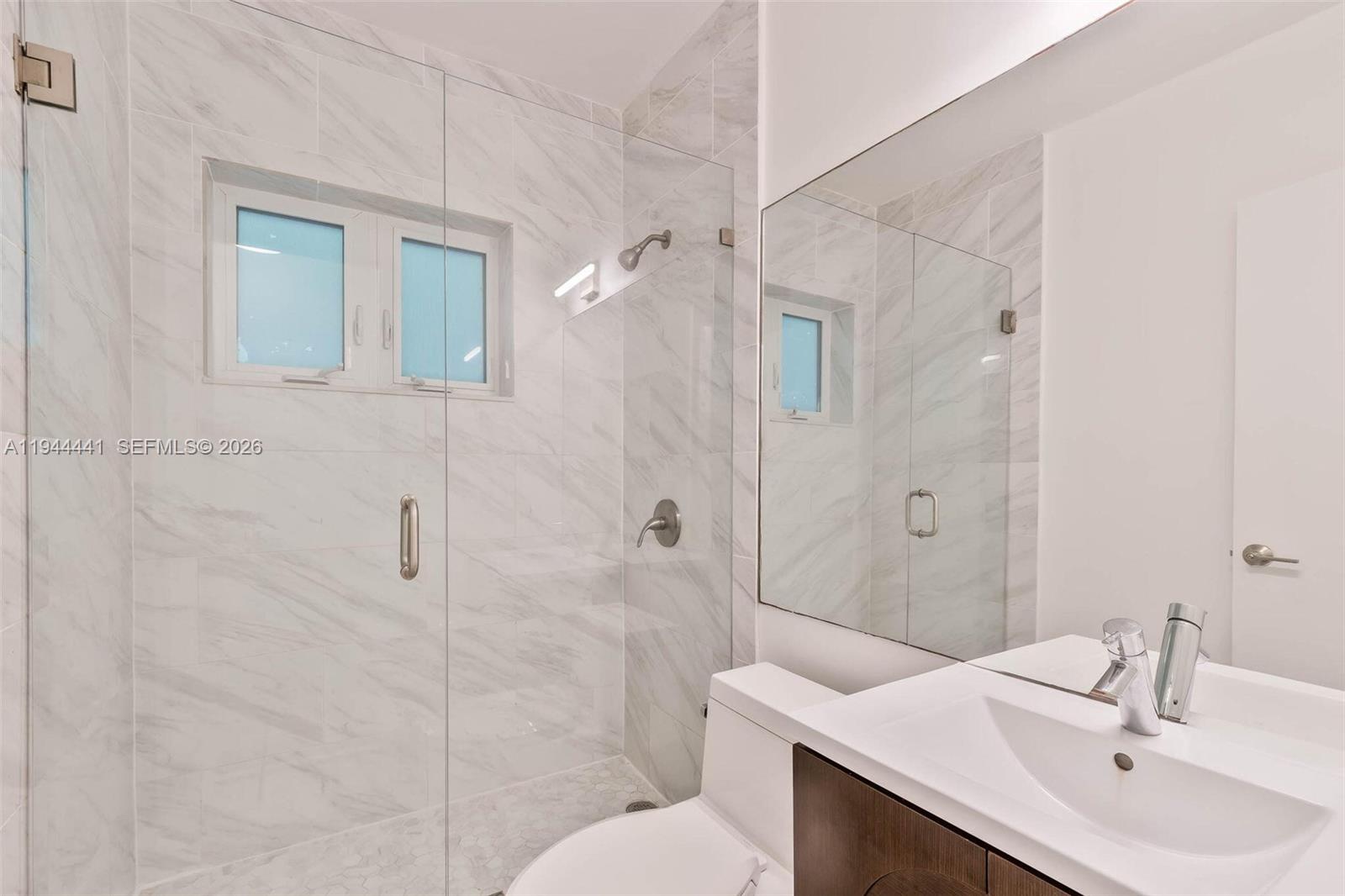680 Northeast 57th Street Miami, FL 33137 - Photo 12 of 42 a bathroom with a sink toilet and shower