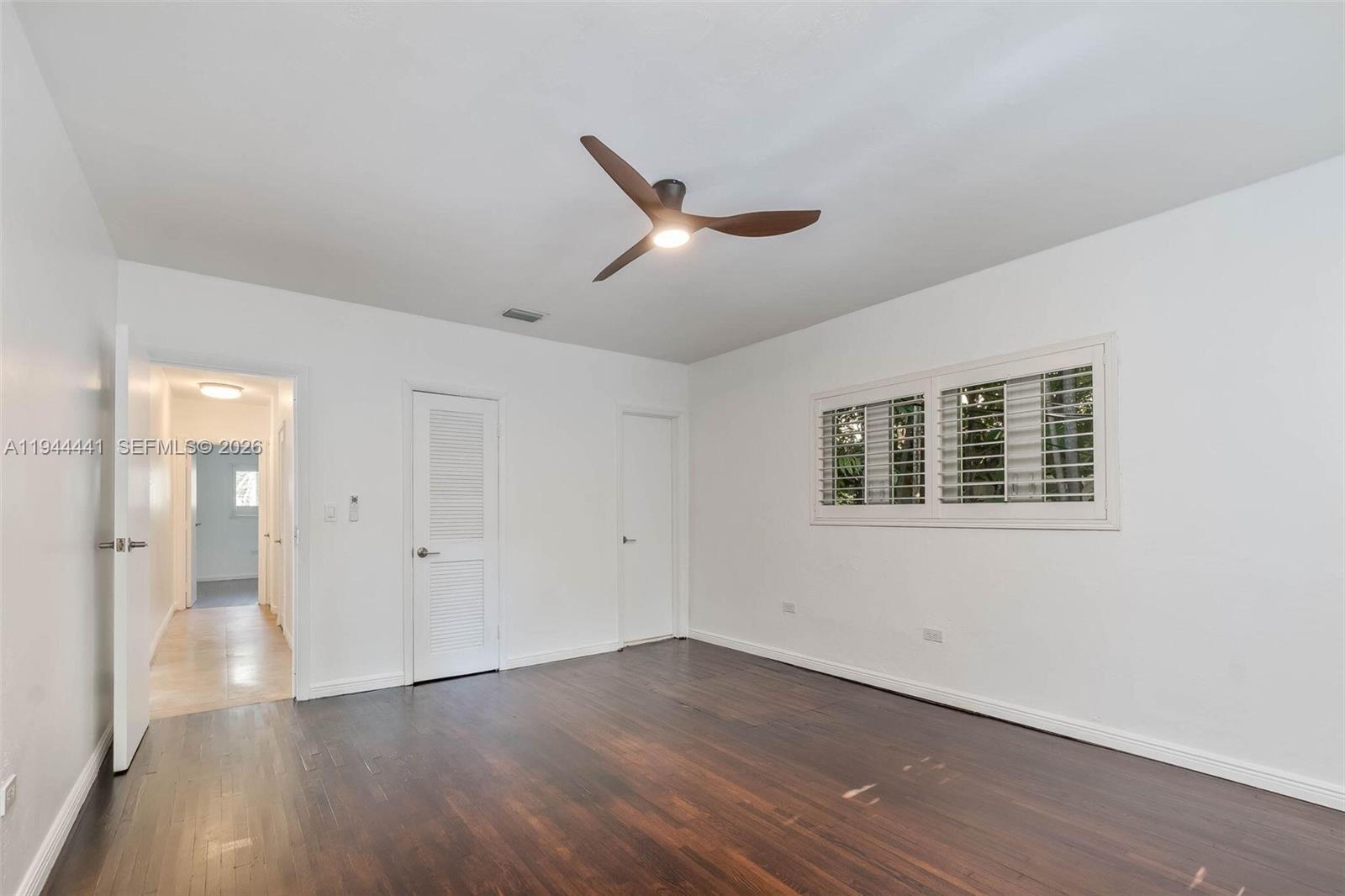 680 Northeast 57th Street Miami, FL 33137 - Photo 14 of 42 an empty room with wooden floor and windows