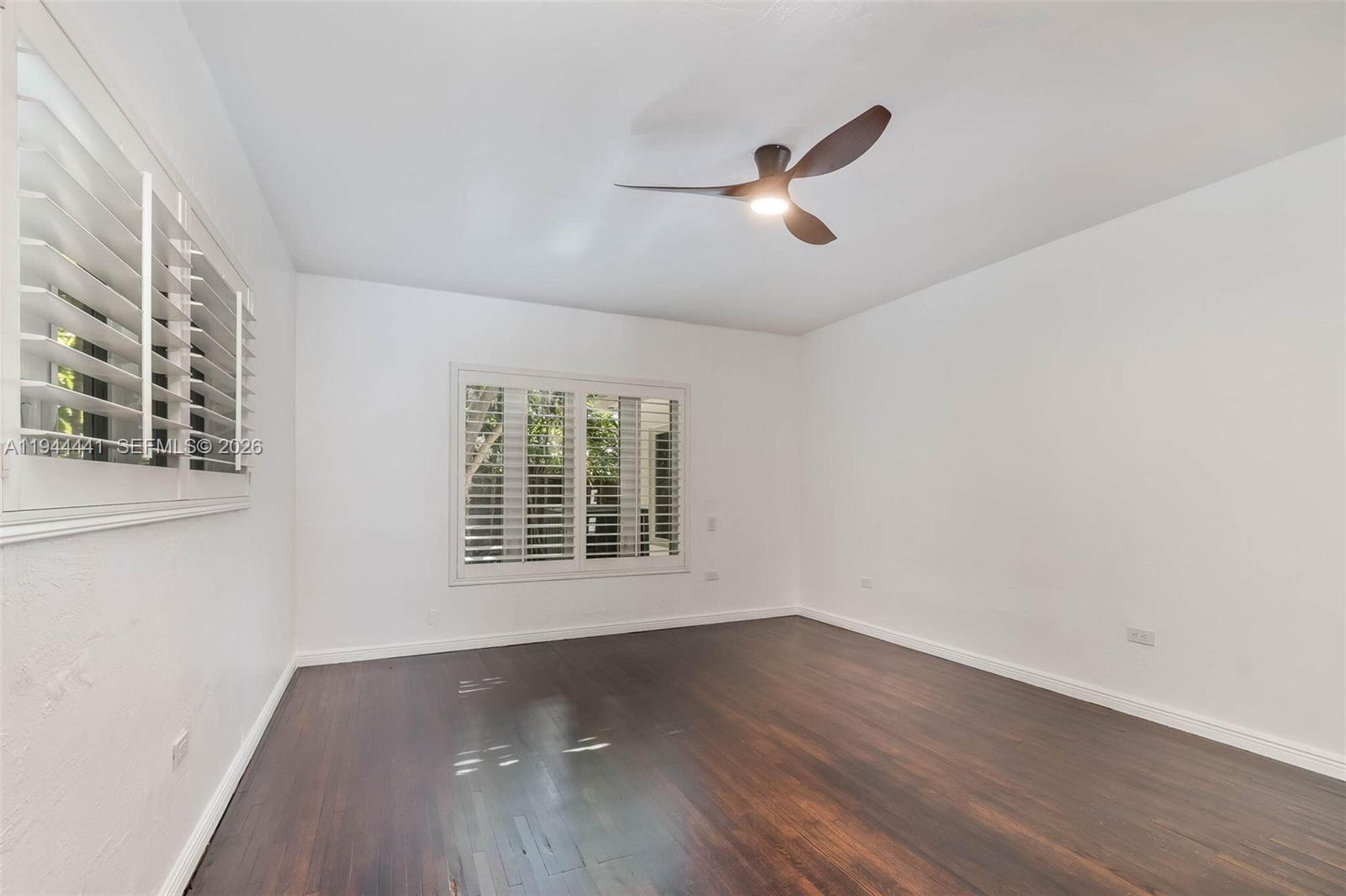 680 Northeast 57th Street Miami, FL 33137 - Photo 15 of 42 a view of empty room with wooden floor and fan