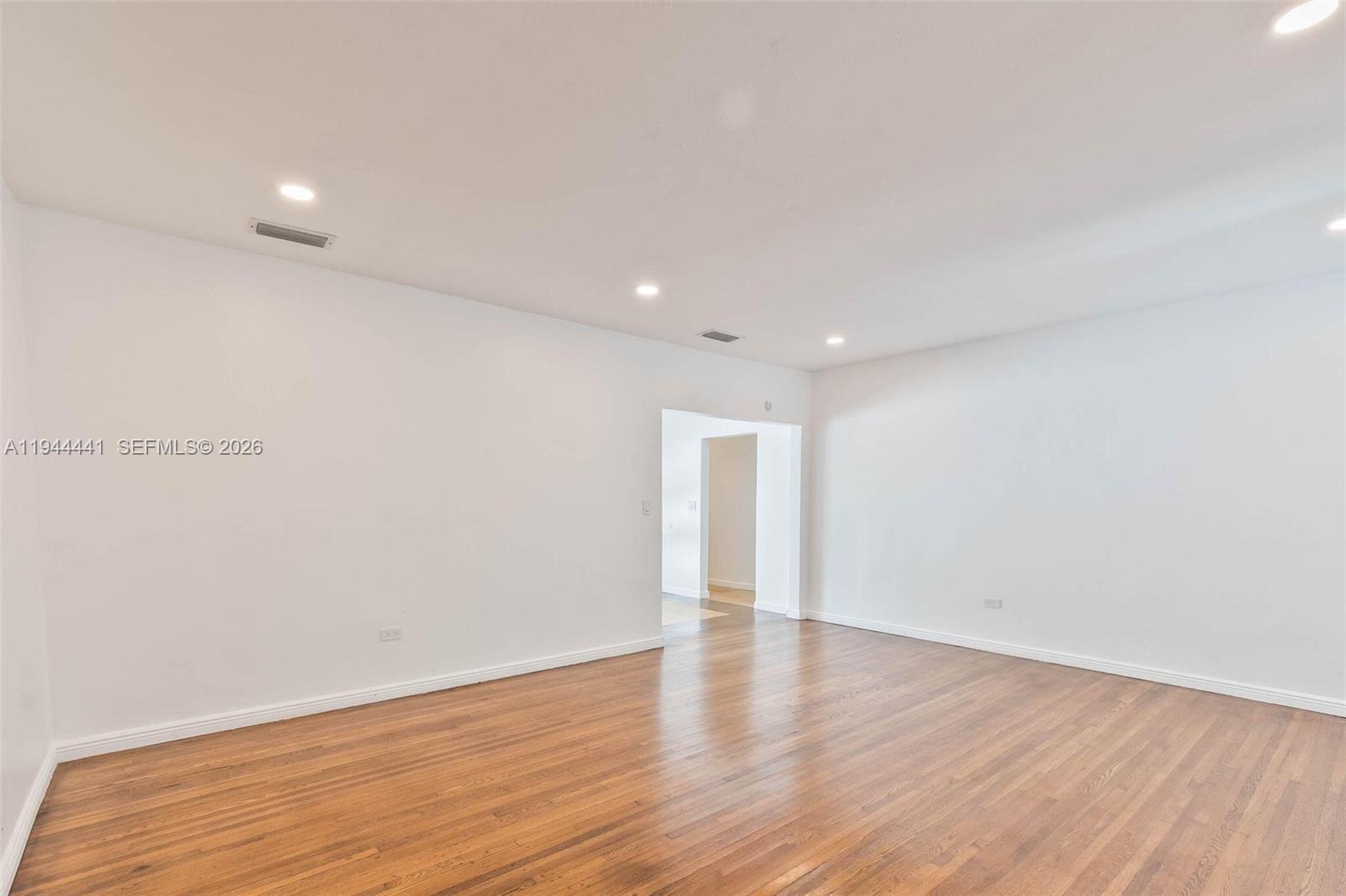 680 Northeast 57th Street Miami, FL 33137 - Photo 19 of 42 a view of an empty room with wooden floor