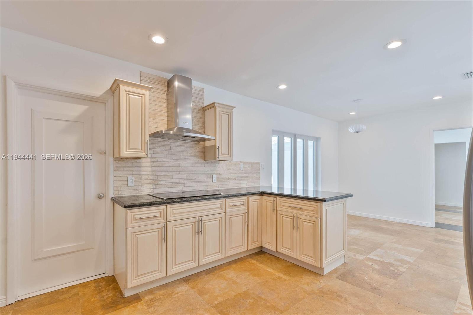 680 Northeast 57th Street Miami, FL 33137 - Photo 26 of 42 a kitchen with a sink and cabinets