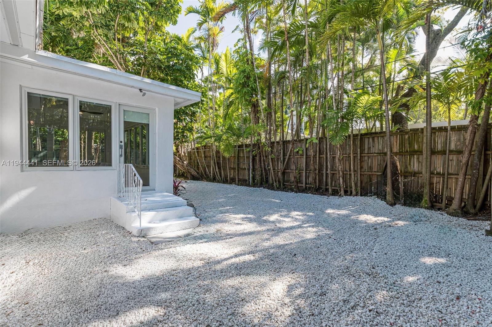 680 Northeast 57th Street Miami, FL 33137 - Photo 30 of 42 a view of a house with backyard and a trees