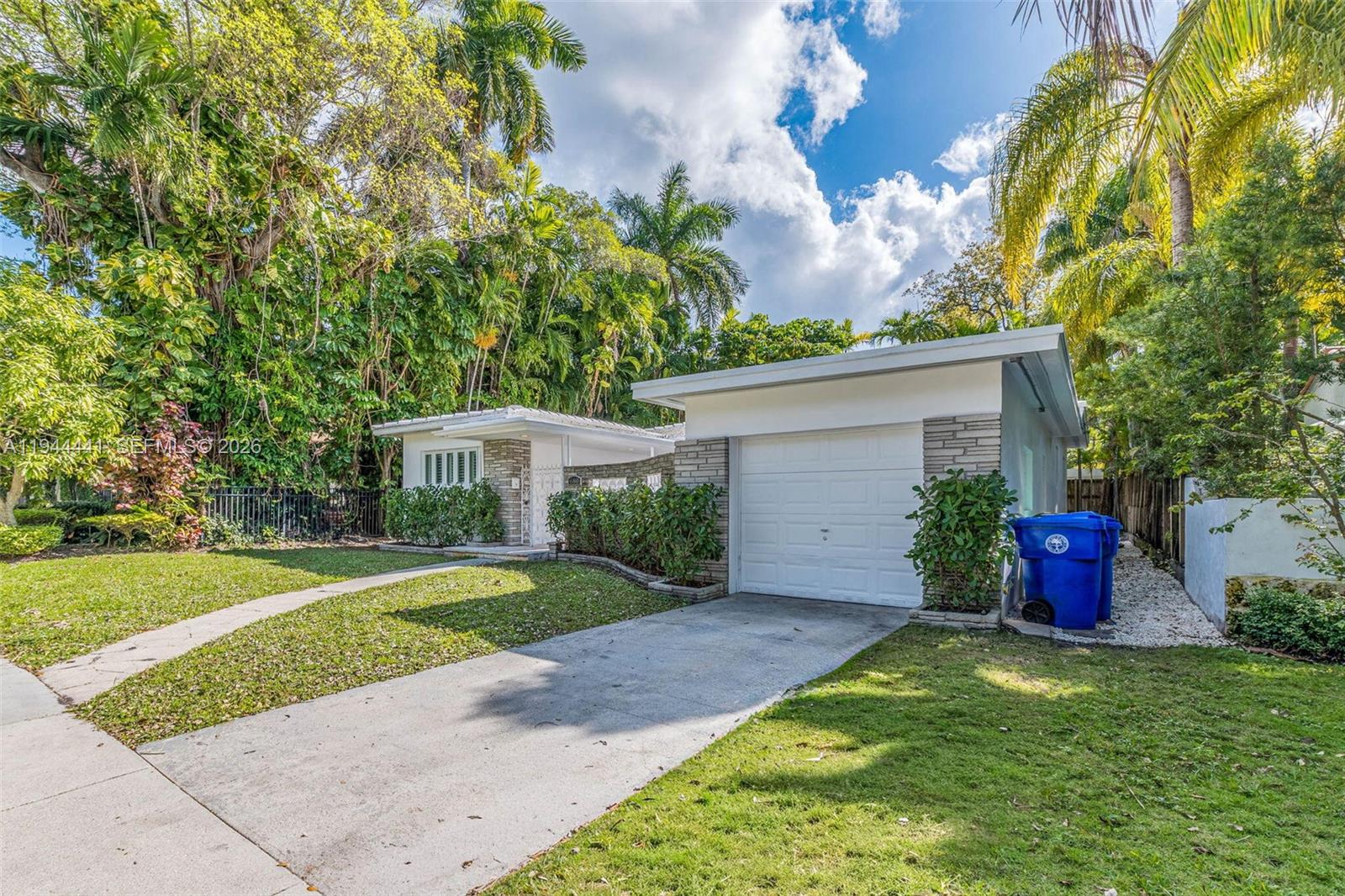 680 Northeast 57th Street Miami, FL 33137 - Photo 3 of 42 a view of a house with a yard and potted plants
