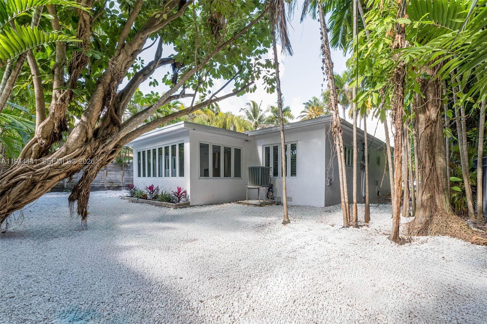 680 Northeast 57th Street Miami, FL 33137 - Photo 34 of 42 a view of a house with a yard and tree s