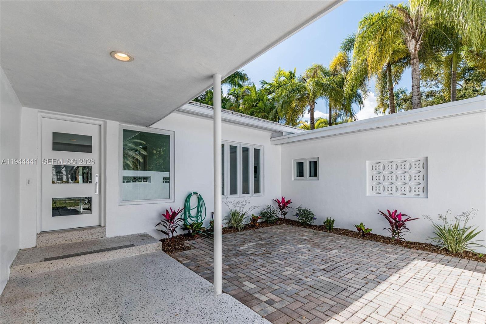 680 Northeast 57th Street Miami, FL 33137 - Photo 5 of 42 a front view of a house with entryway