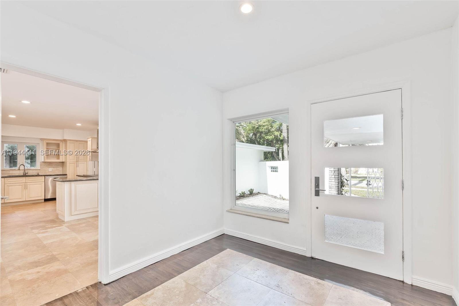 680 Northeast 57th Street Miami, FL 33137 - Photo 9 of 42 an empty room with mirror and windows