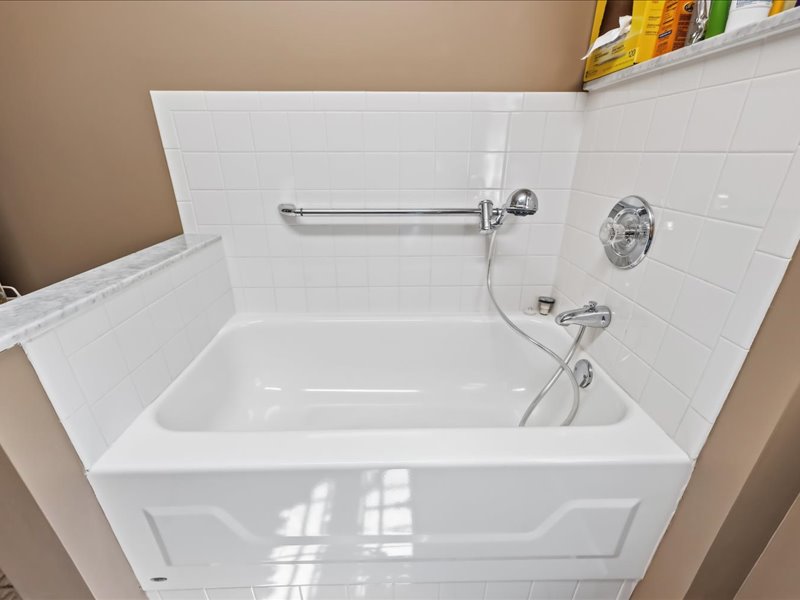 1168 Mt Pleasant Road Bangor, PA 18013 - Photo 61 of 100 White subway tiles surround a deep soaking tub complete with a handy grab bar.