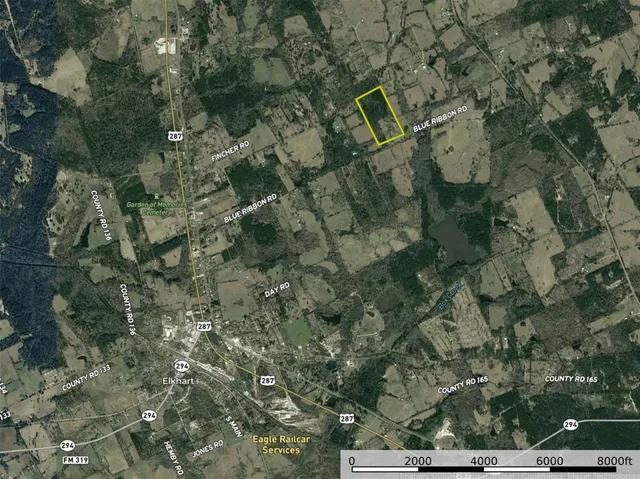 a aerial view of a house with a yard and street view