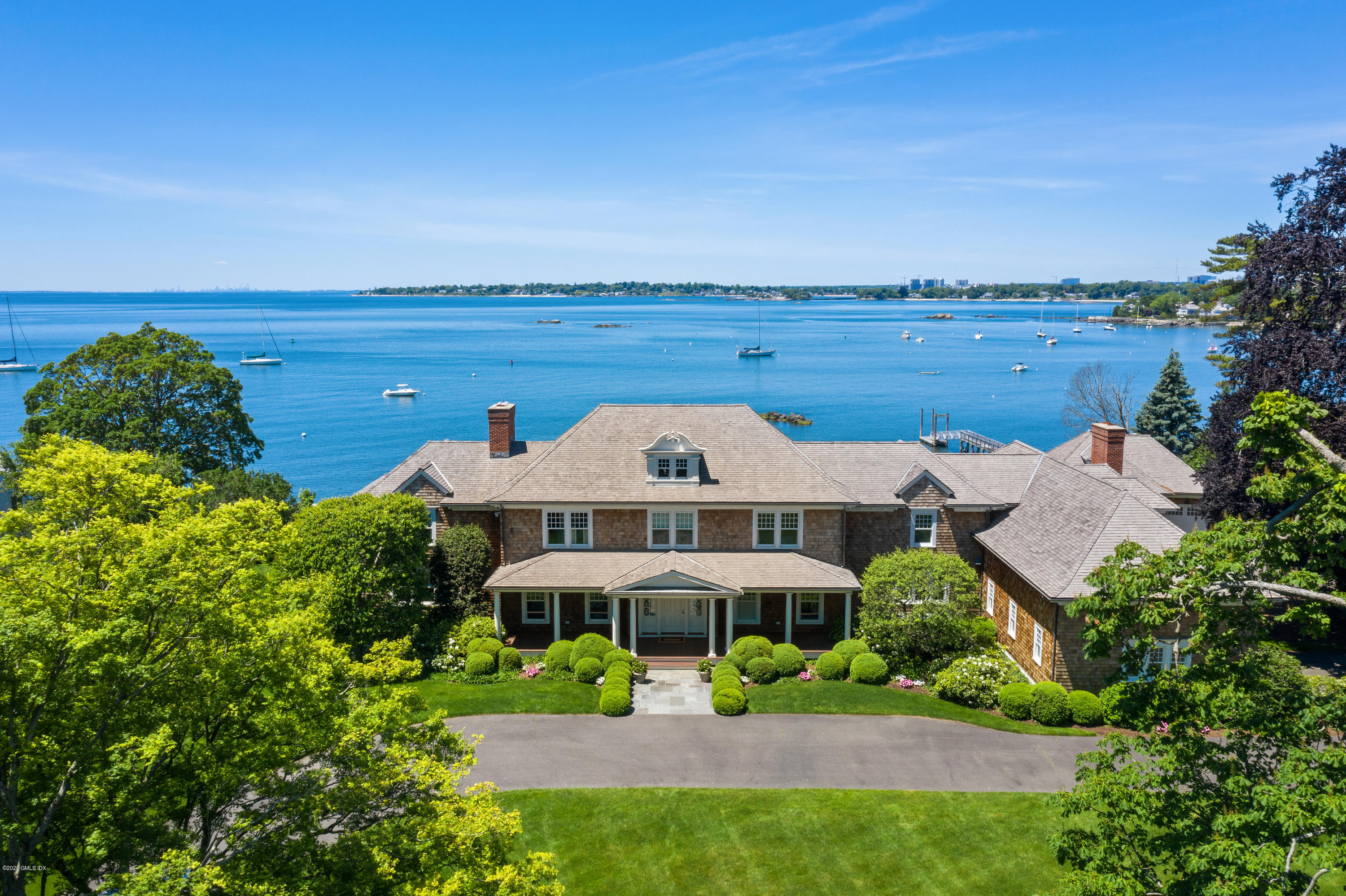 224 Long Neck Point Road Darien, CT 06820 - Photo 1 of 33 a front view of a house with a yard