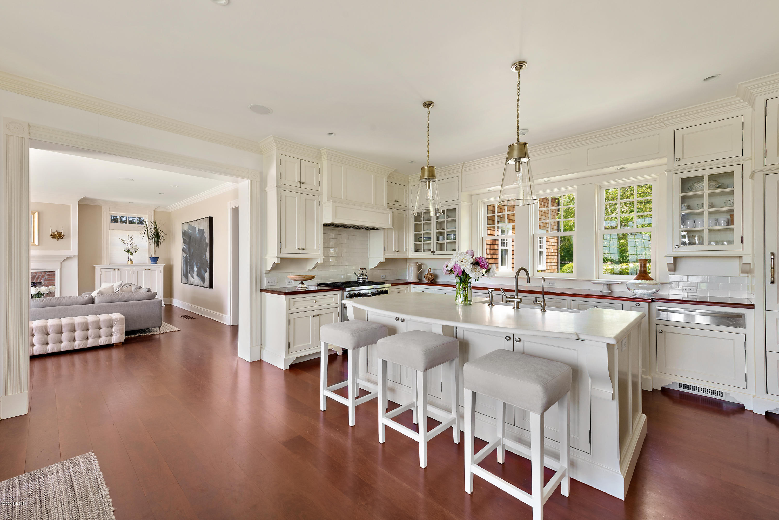 224 Long Neck Point Road Darien, CT 06820 - Photo 15 of 33 a kitchen with stainless steel appliances granite countertop a stove top oven a sink a dining table and chairs with wooden floor
