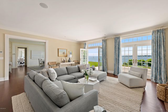 a hallway with white cabinets and wooden floor