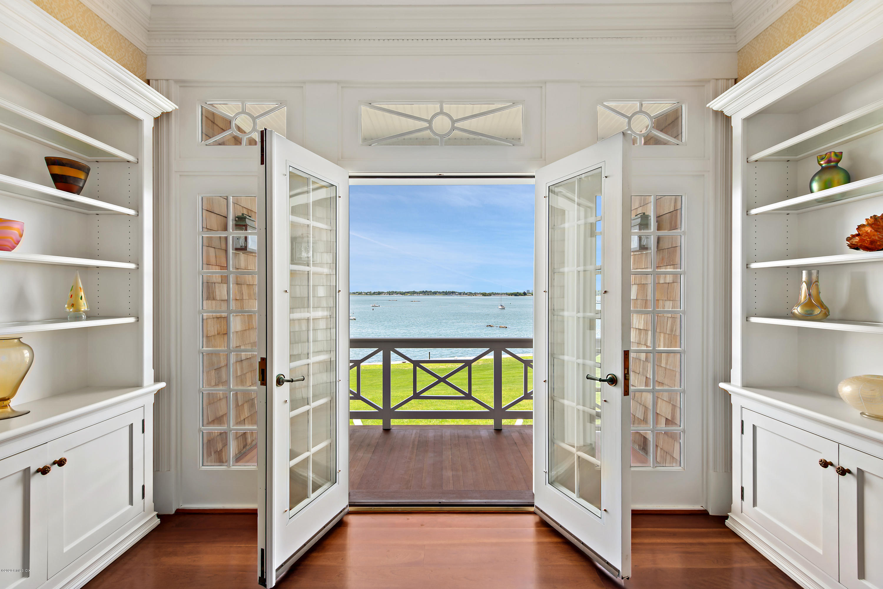 224 Long Neck Point Road Darien, CT 06820 - Photo 17 of 33 a hallway with white cabinets and wooden floor