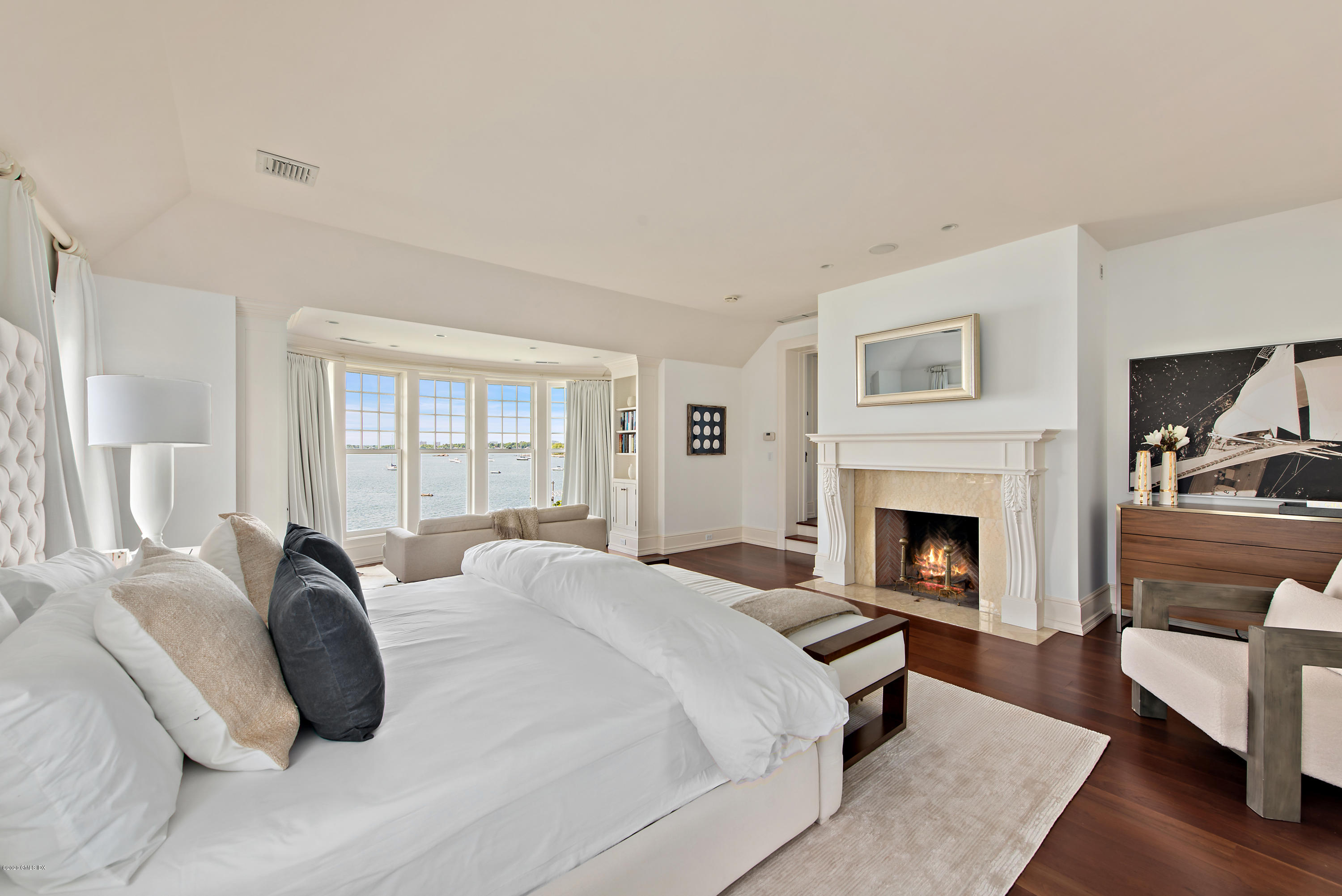 224 Long Neck Point Road Darien, CT 06820 - Photo 18 of 33 a spacious bedroom with a bed a couch and large window