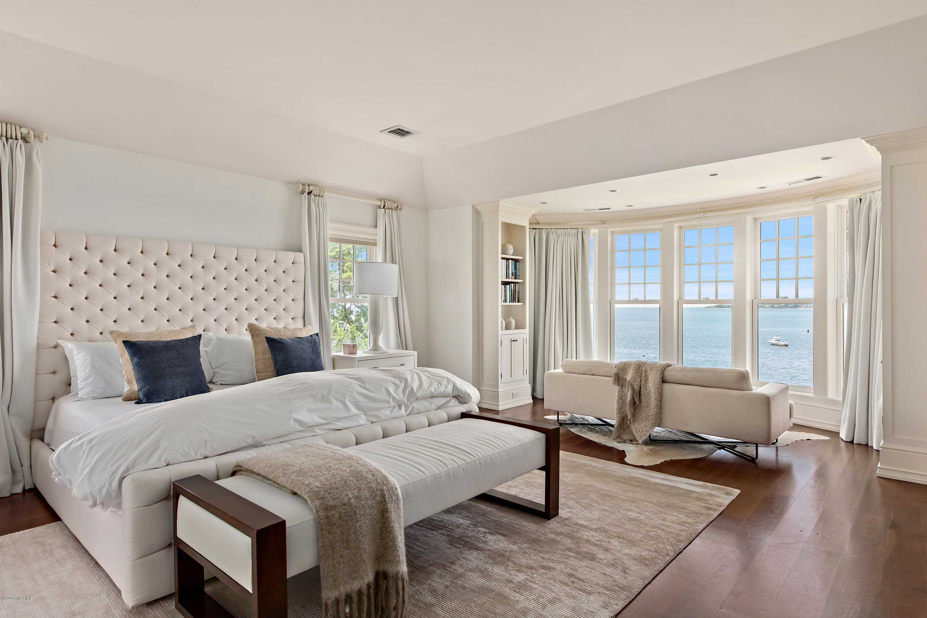 224 Long Neck Point Road Darien, CT 06820 - Photo 19 of 33 a bedroom with a bed and large windows