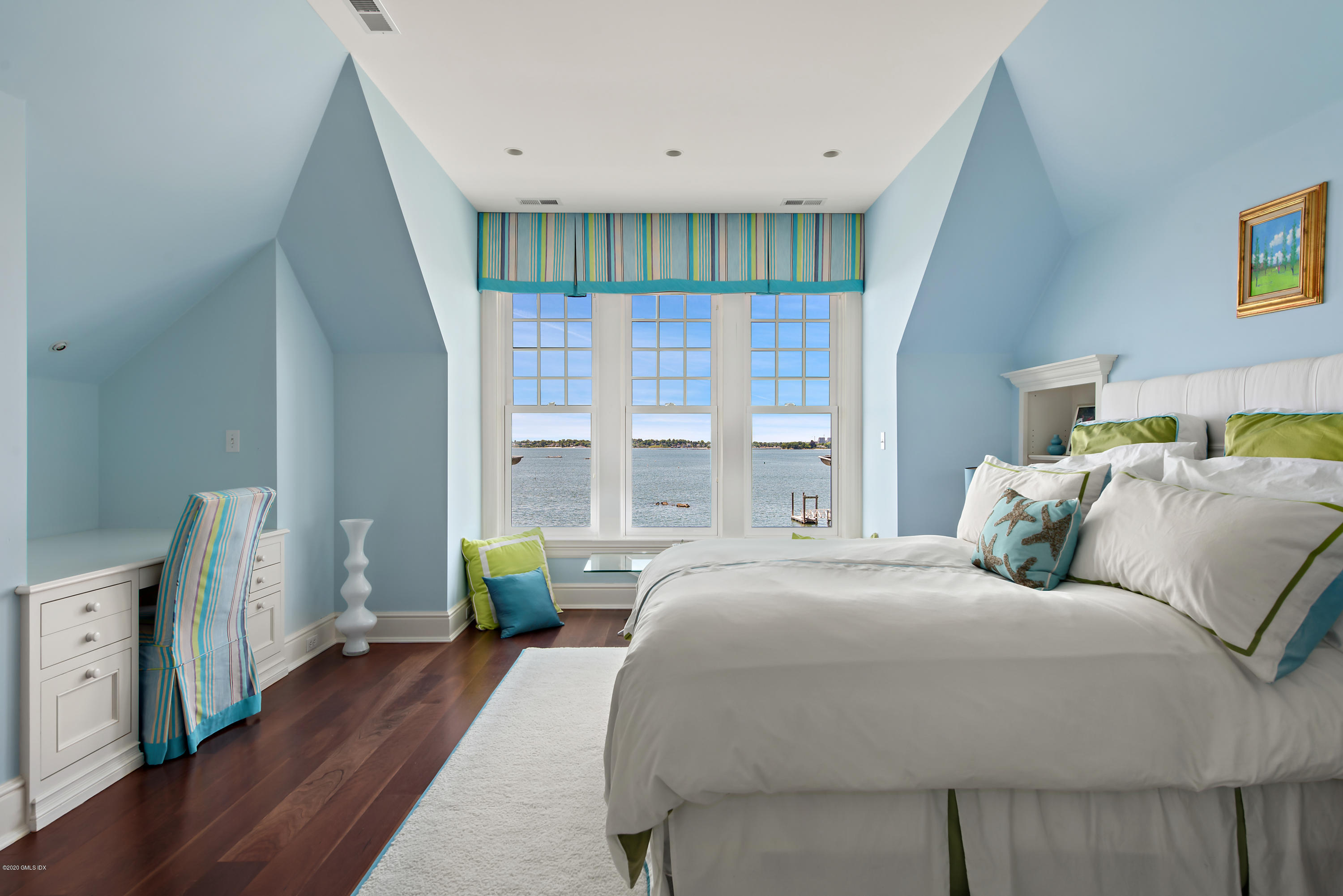 224 Long Neck Point Road Darien, CT 06820 - Photo 25 of 33 a bedroom with a bed and a wooden floor