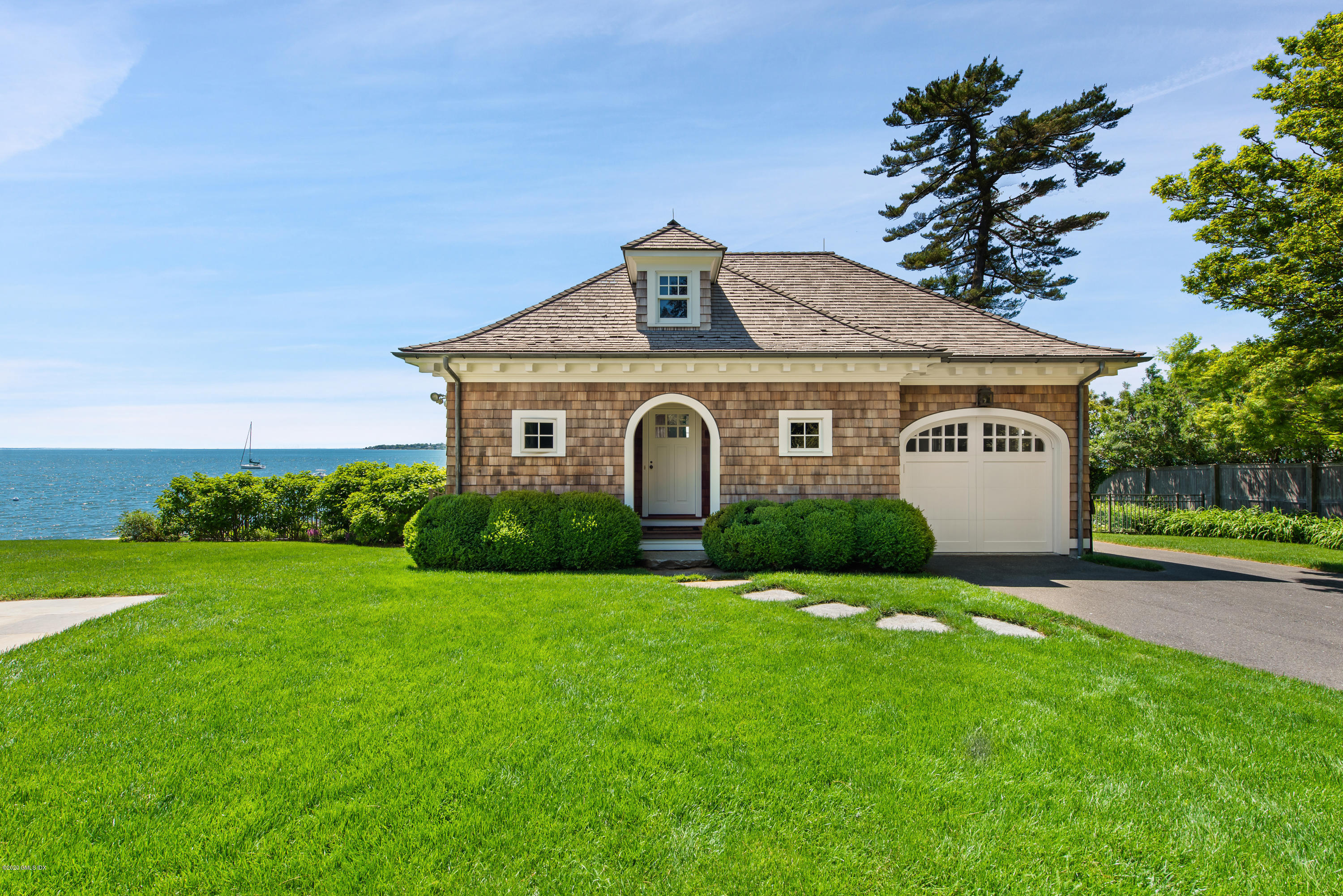 224 Long Neck Point Road Darien, CT 06820 - Photo 26 of 33 a front view of a house with a yard and garage