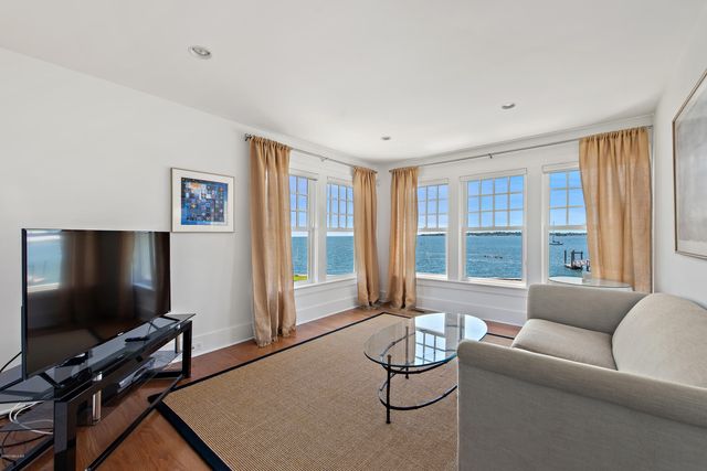 a living room with kitchen island furniture and a wooden floor