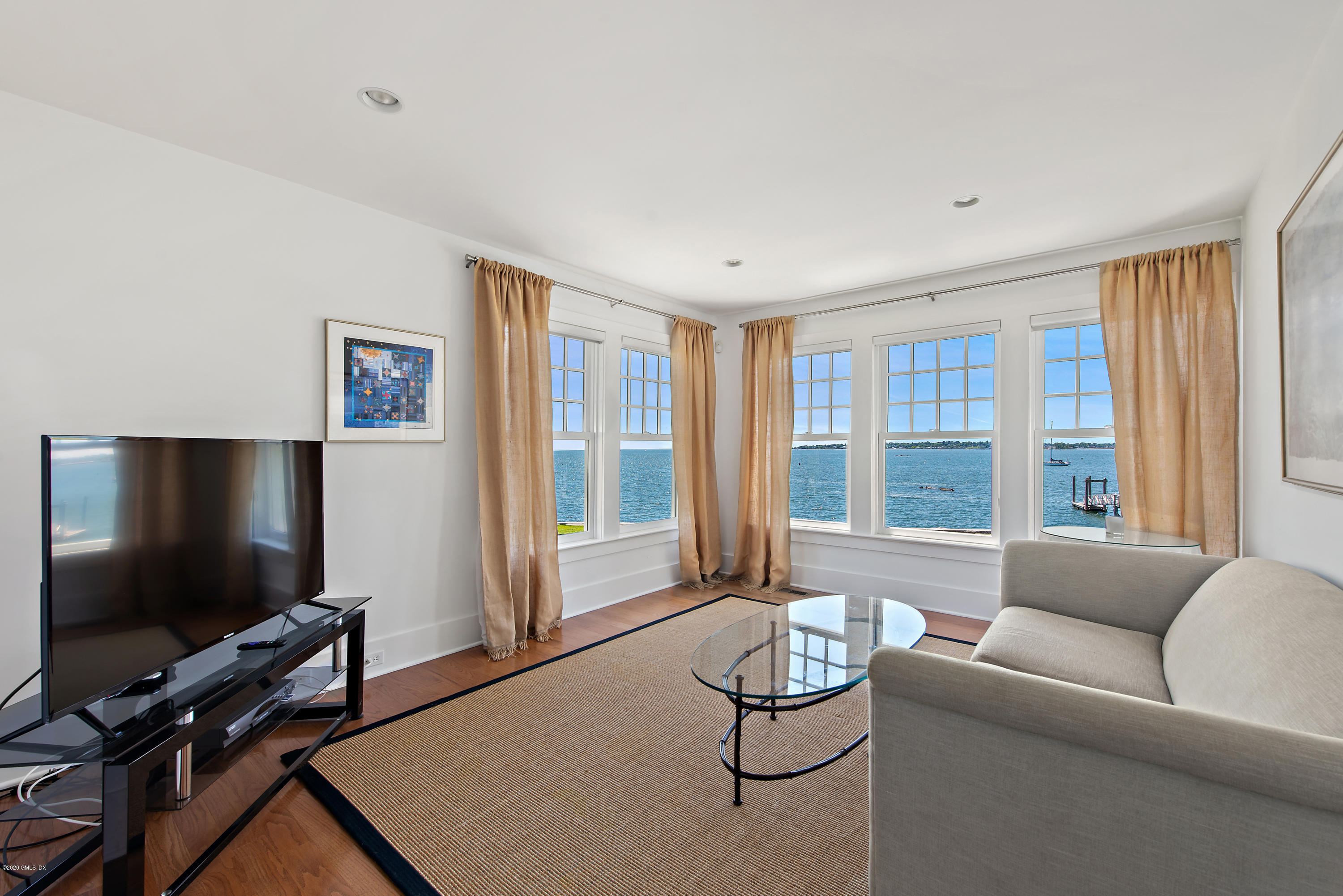 224 Long Neck Point Road Darien, CT 06820 - Photo 27 of 33 a living room with furniture and a flat screen tv