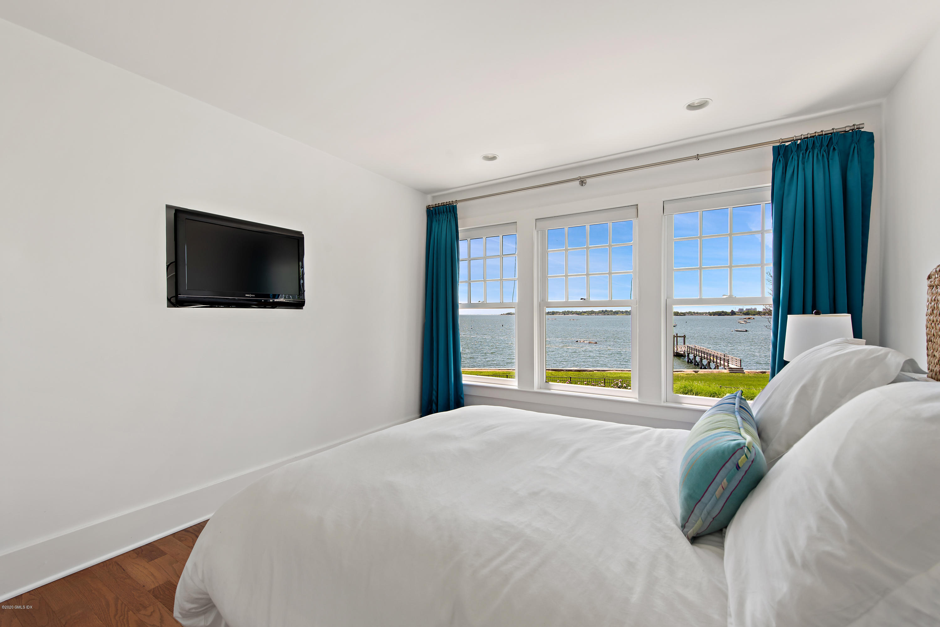 224 Long Neck Point Road Darien, CT 06820 - Photo 28 of 33 a view of an empty room with a flat screen tv